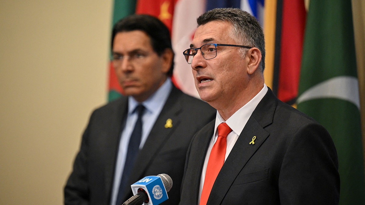 Israeli Foreign Minister Gideon Saar (R) and Israeli Ambassador to the U.N. Danny Danon (L) speak to journalists ahead of a United Nations Security Council meeting at U.N. headquarters on August 5, 2025 in New York