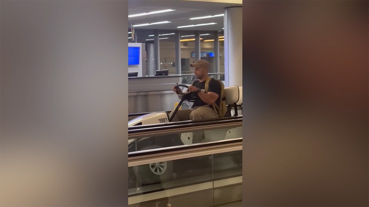 Man driving the golf cart on the walkway at airport