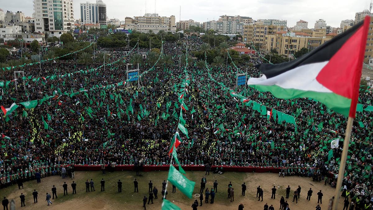 A Palestinian flag flies as Hamas supporters take part in a rally marking the 30th anniversary of Hamas' founding, in Gaza City December 14, 2017. REUTERS/Suhaib Salem - RC19EF93D000