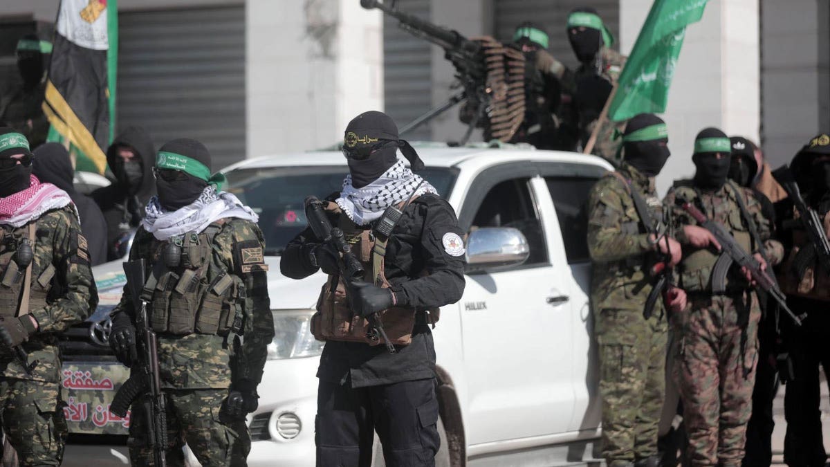 Members of the Hamas terror group gather in Gaza in preparation for the release of four female hostages as part of the ceasefire deal with Israel.