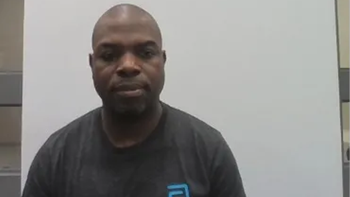 Mukendi Mbiya wearing a black t-shirt in his mugshot