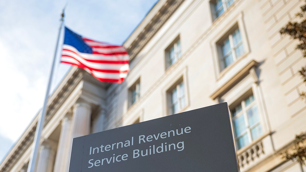 Internal Revenue Service Building sign with American flag flying in the background