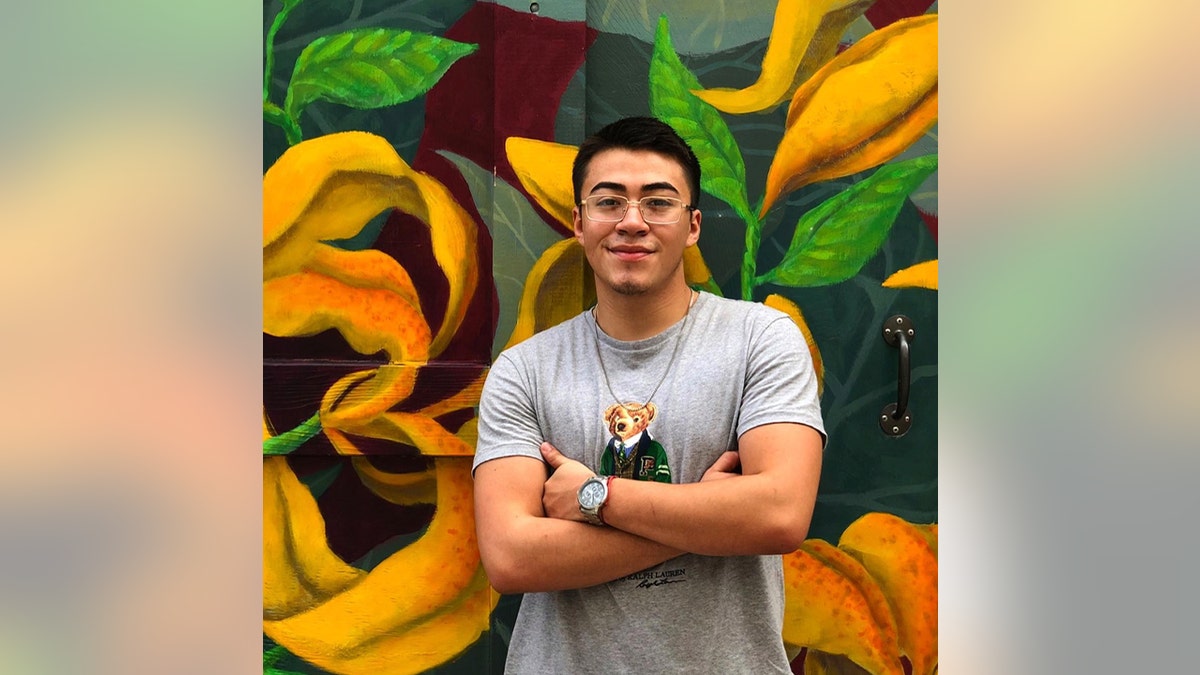 Kevin Mares in front of a mural