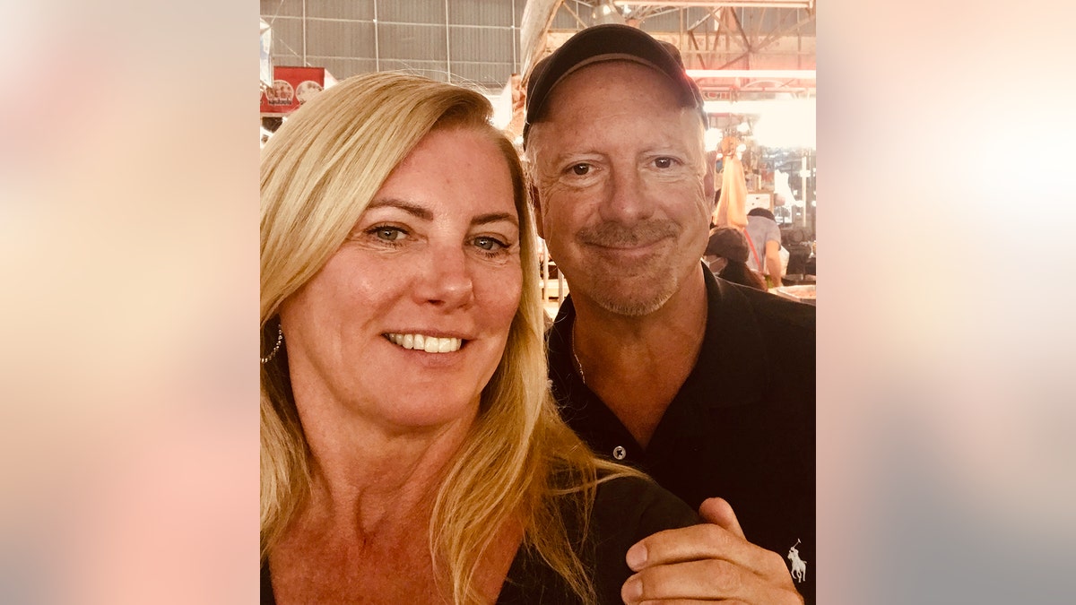 A selfie of Larry Rudolph and Lori Milliron smiling.