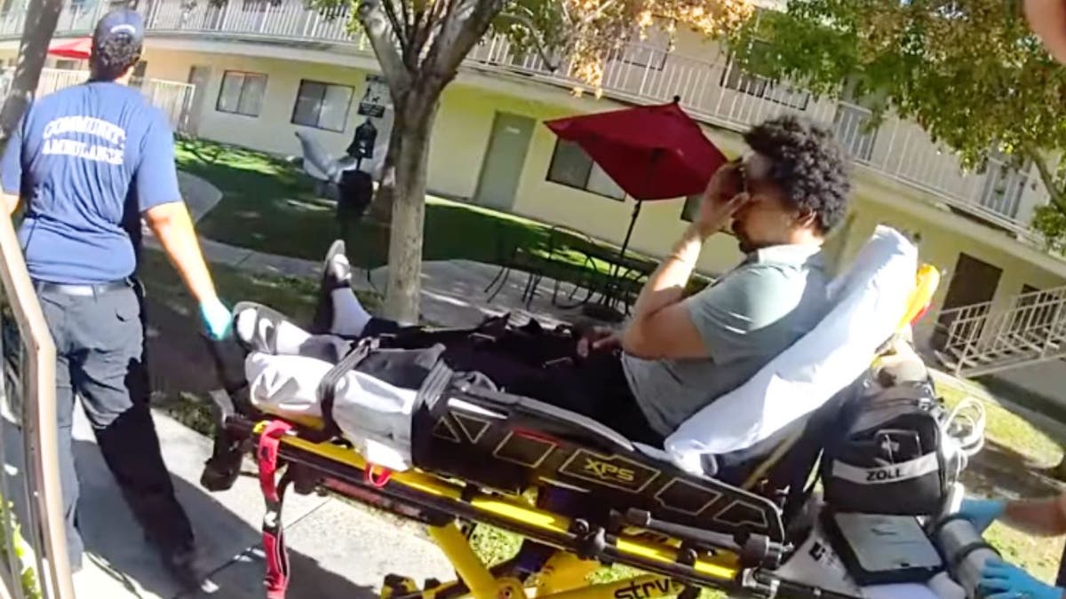 Shane Tamura taken away on gurney