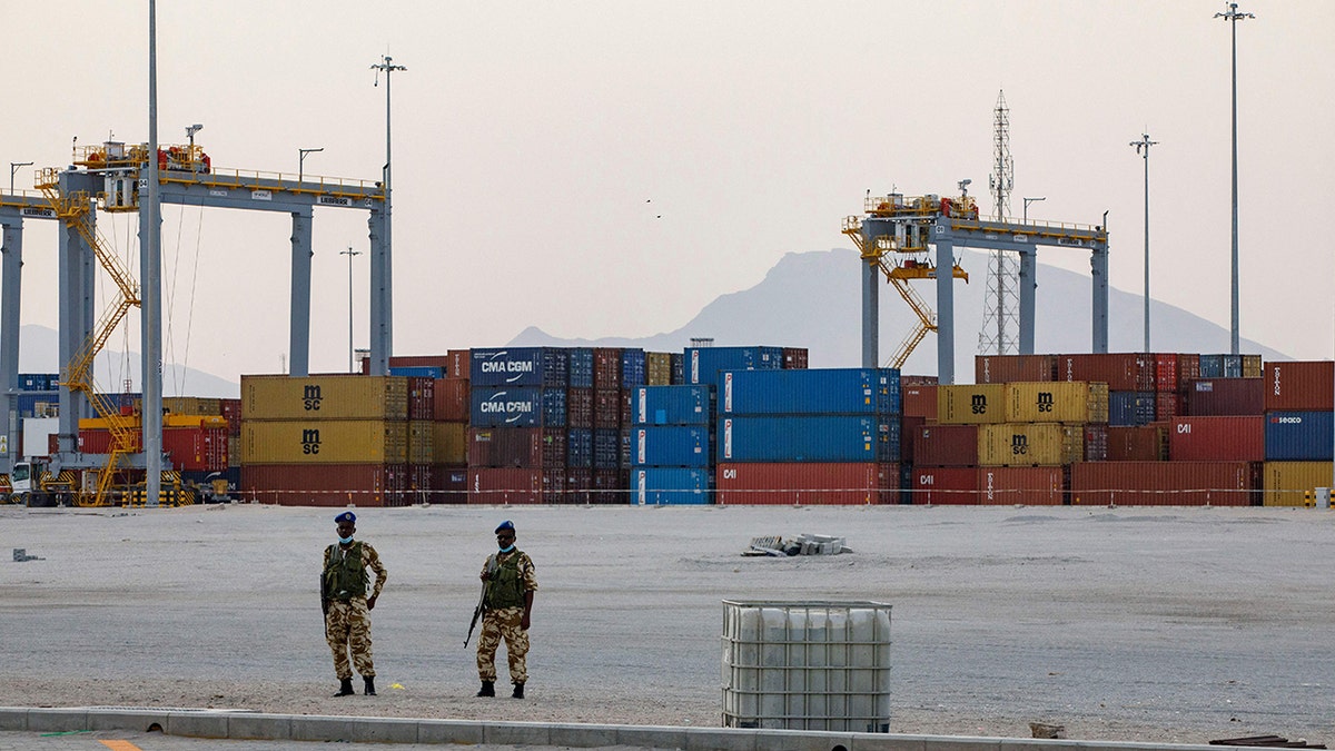 Somaliland security personnel stand watch in front of shipping containers being stored at Berbera Port.