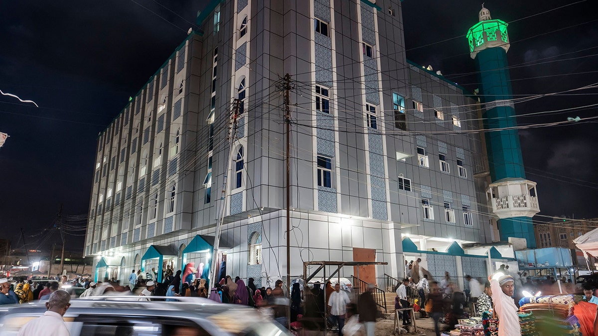 People walk in front of a mosque in the city of Hargeisa, Somaliland, on September 16, 2021.   