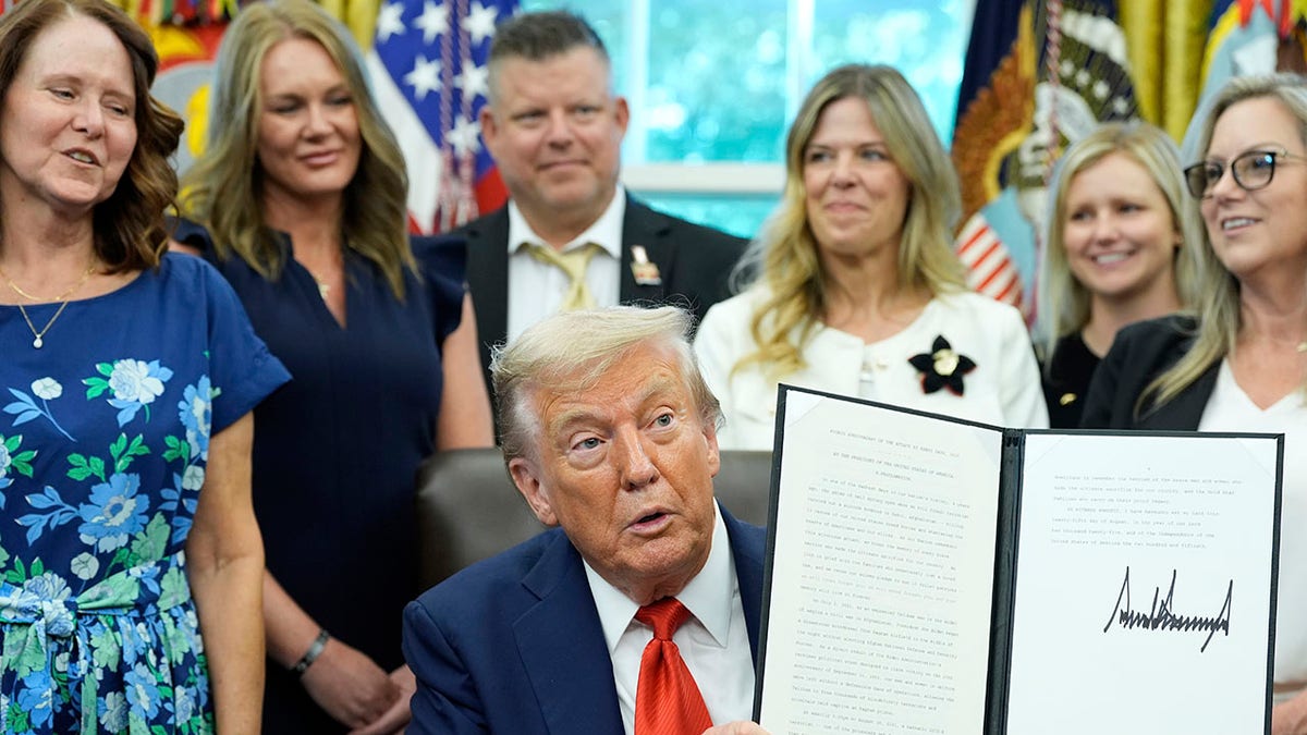 President Donald Trump signs a proclamation at the White House.