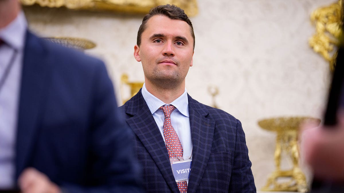 Turning Point USA co-founder Charlie Kirk stands in the back of the room as U.S. President Donald Trump speaks during a swearing in ceremony for interim U.S. Attorney for Washington, D.C.