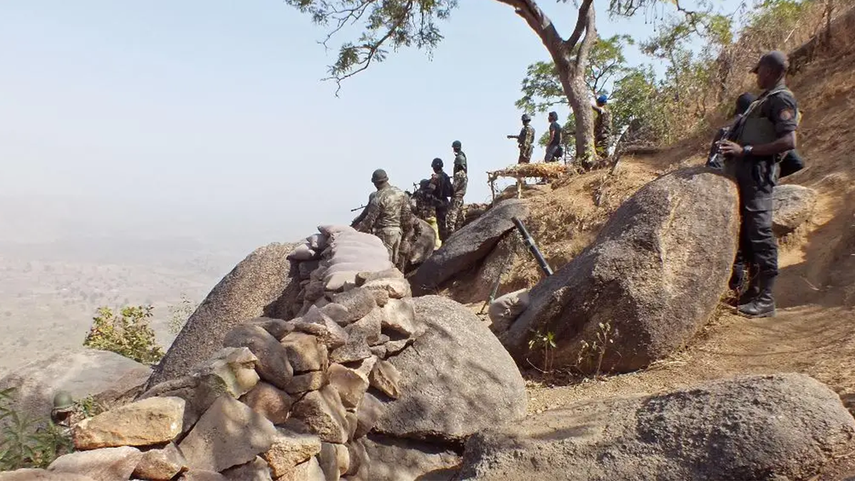 In this photo taken on Thursday, Feb. 19, 2015, Cameroon soldiers stand guard at a lookout post as they take part in operations against the Islamic extremist group Boko Haram near the village of Mabass, Cameroon. Cameroon officials say prisons are overcrowded with suspected Islamic extremists whose insurgency has spilled from Nigeria.