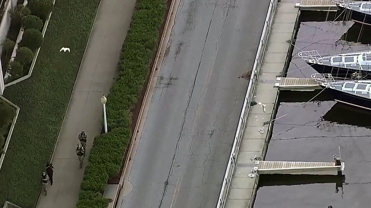 Armed officers patrol near Naval Academy waterfront during lockdown