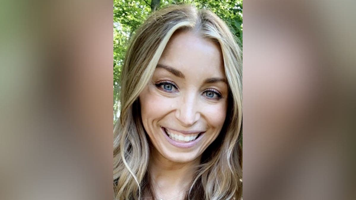 Close-up headshot of Julie Rizzitello outdoors, smiling