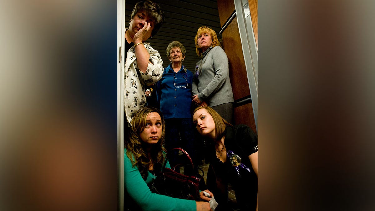 (From left to right) Charlene McLeod, Katherine McLeod, Ginger McLeod, Michelle Strick (bottom left) and Samantha McLeod, family members of victim Kaysi McLeod, listen to a recording of Scott Lee Kimball's court hearing at the Boulder County Justice center in Boulder, Colorado, Thursday, Oct. 8, 2009. Kimball pleaded guilty to the murder of four people and was sentenced to 70 years in prison. 