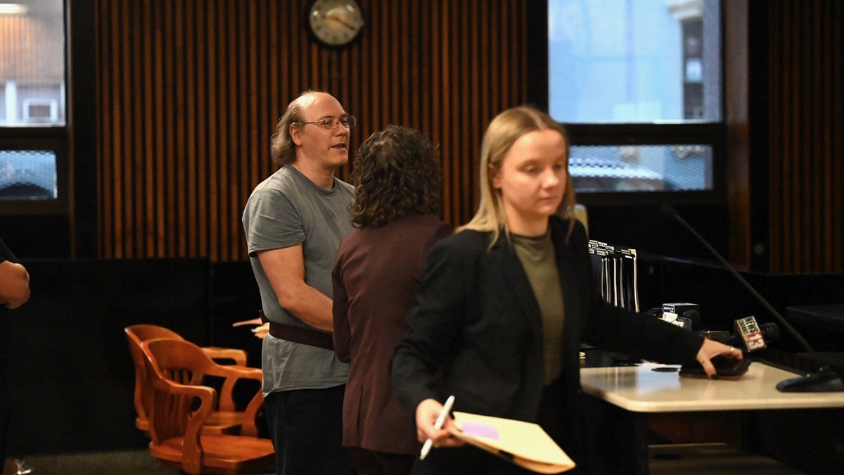 Lorenz F. Kraus speaking with attorney in court