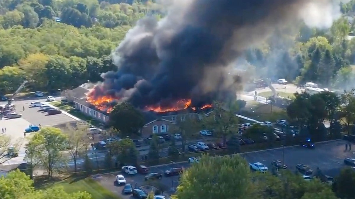 aerial image of church on fire and black smoke billowing