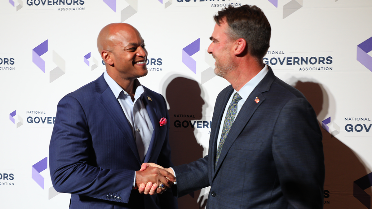 Govs. Moore and Stitt shake hands