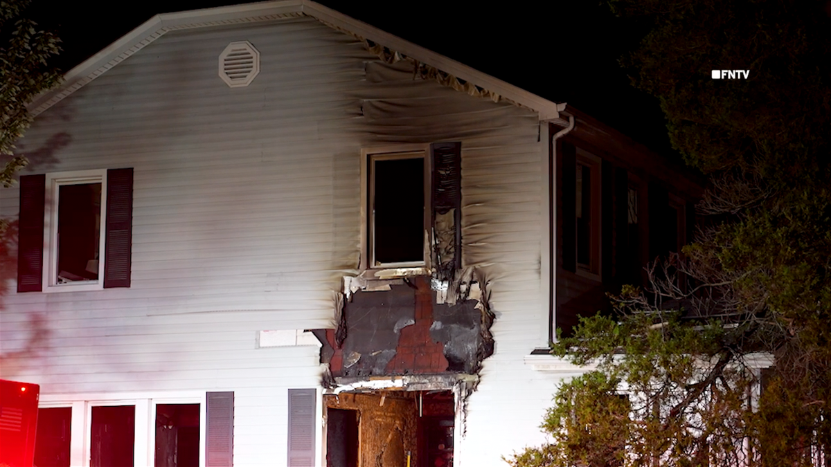 a still image taken from video shows fire damage on the side of the home