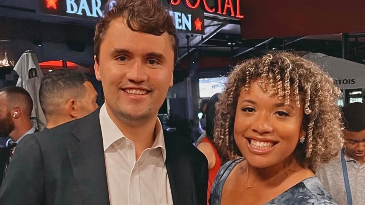 Charlie Kirk on the left posing for photo smiling at camera with Savannah Craven, a pro-life influencer, on the right.
