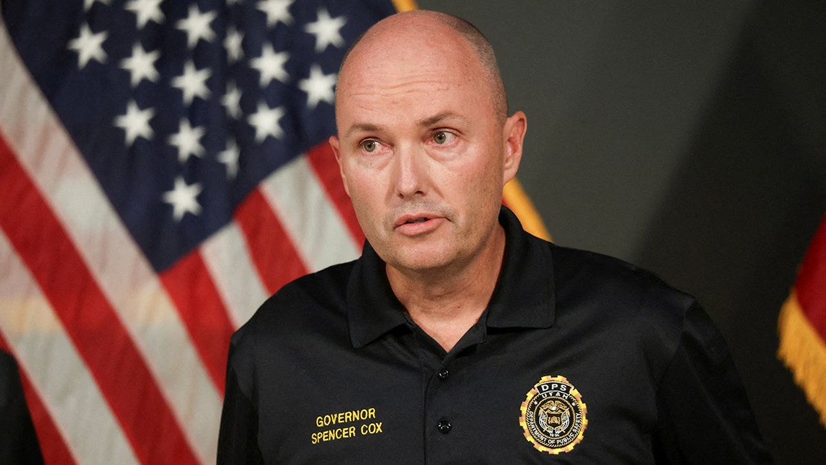 Utah Governor Spencer Cox in black polo shirt speaking