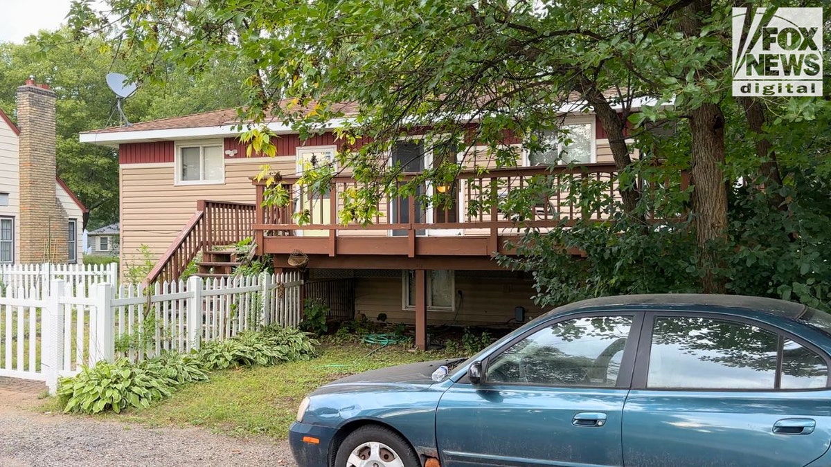 Two-story split-level house in St. Louis Park with beige siding, red deck, and fenced yard, believed to be where Robin Westman stayed before the shooting.
