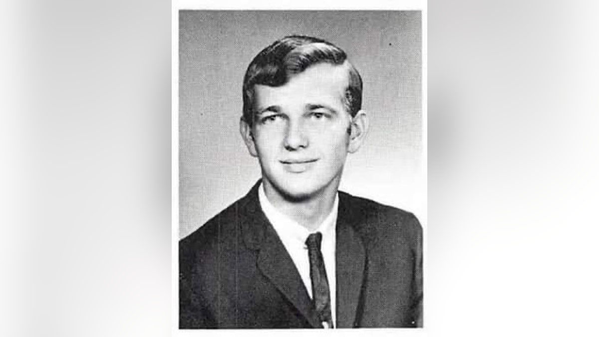 A young Warren Forrest posing in a suit.