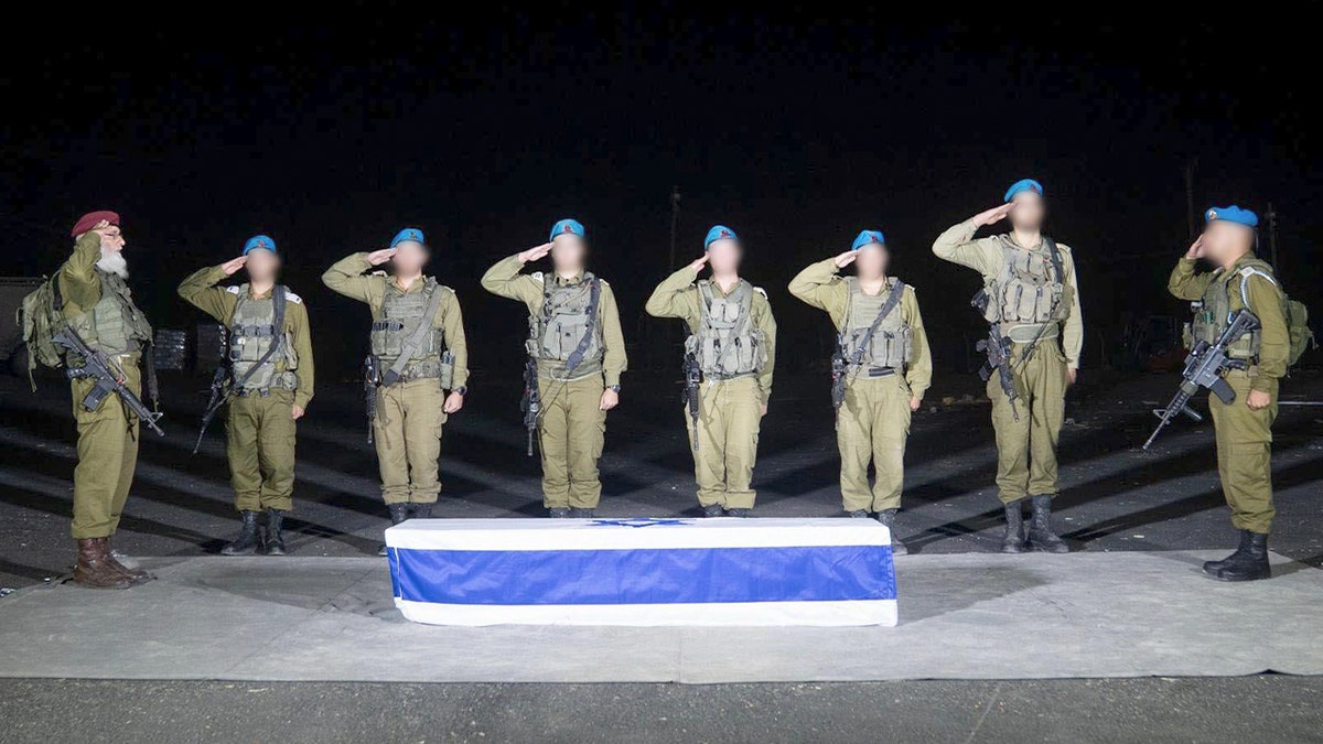 Israeli soldiers saluting Tal Haimi's coffin