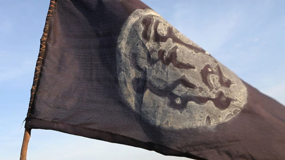 A Boko Haram flag flutters from an abandoned command post in Gamboru deserted after Chadian troops chased them from the border town on February 4, 2015. 