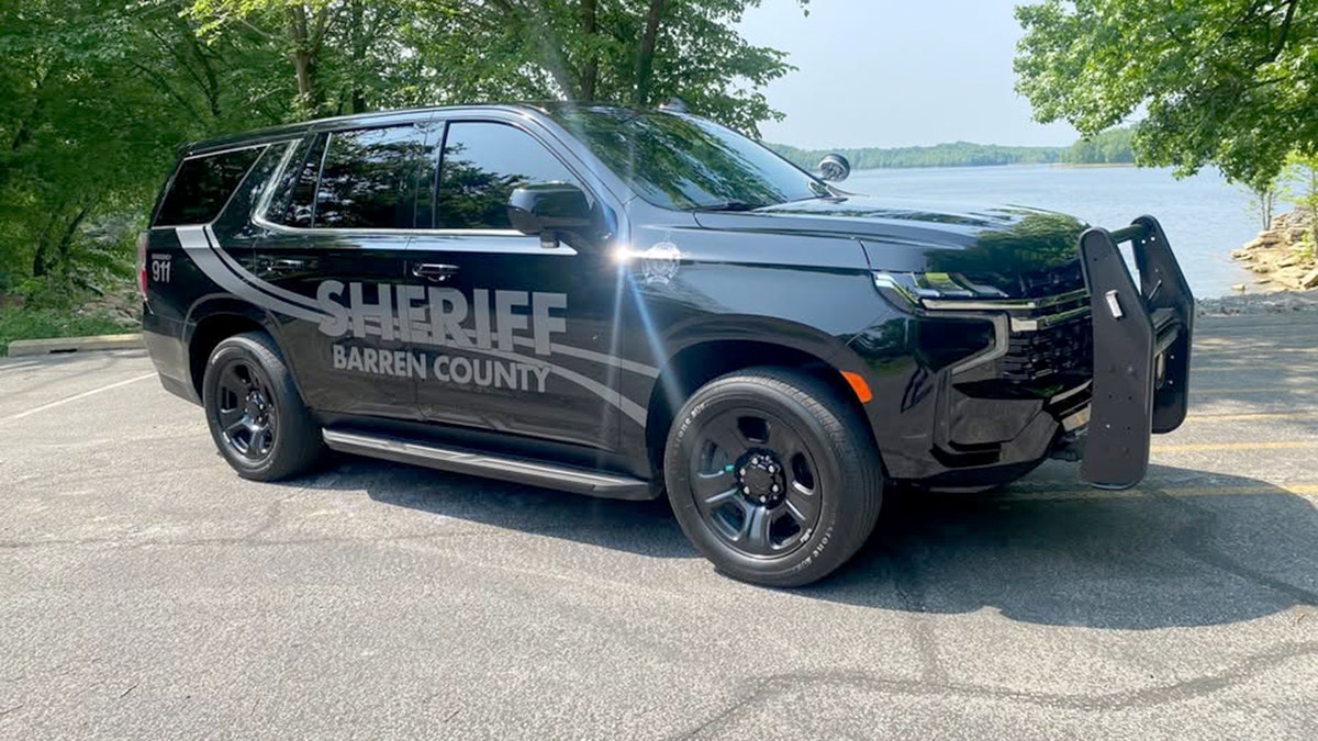 A black Barren County Sheriff's Office vehicle parked in front of a lake