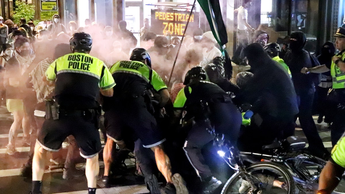 Police detain a rioter in Boston