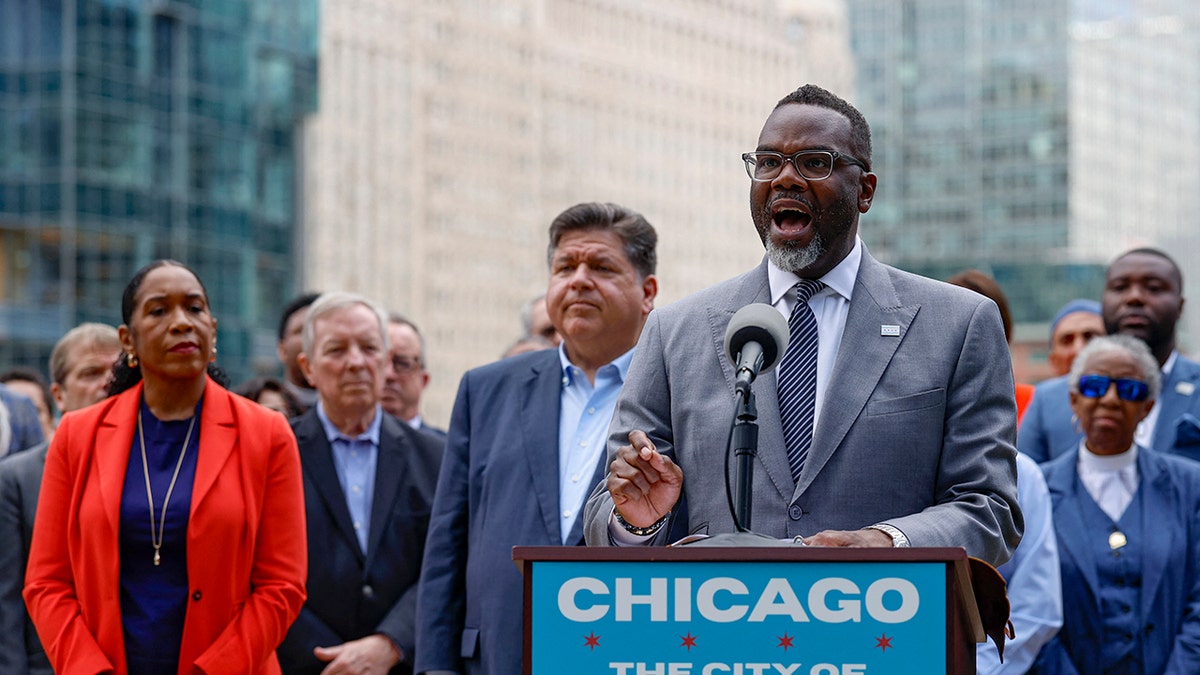 Chicago Mayor Brandon, Governor Pritzker speak behind a podium