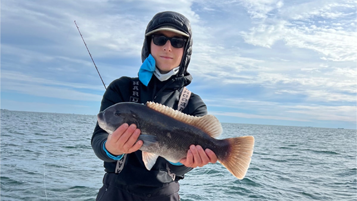 Eric Tarpinian-Jachym seen in a picture holding a fish