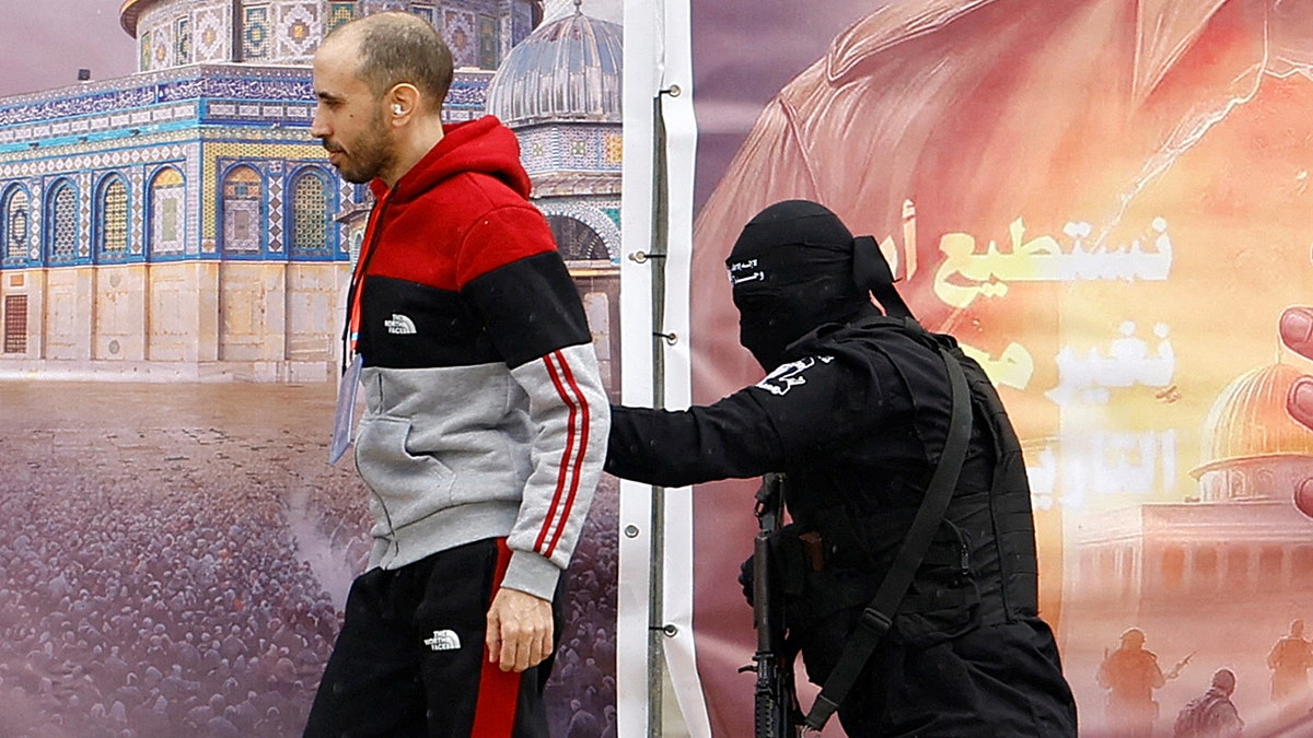 Hamas terrorist with Israeli captive.