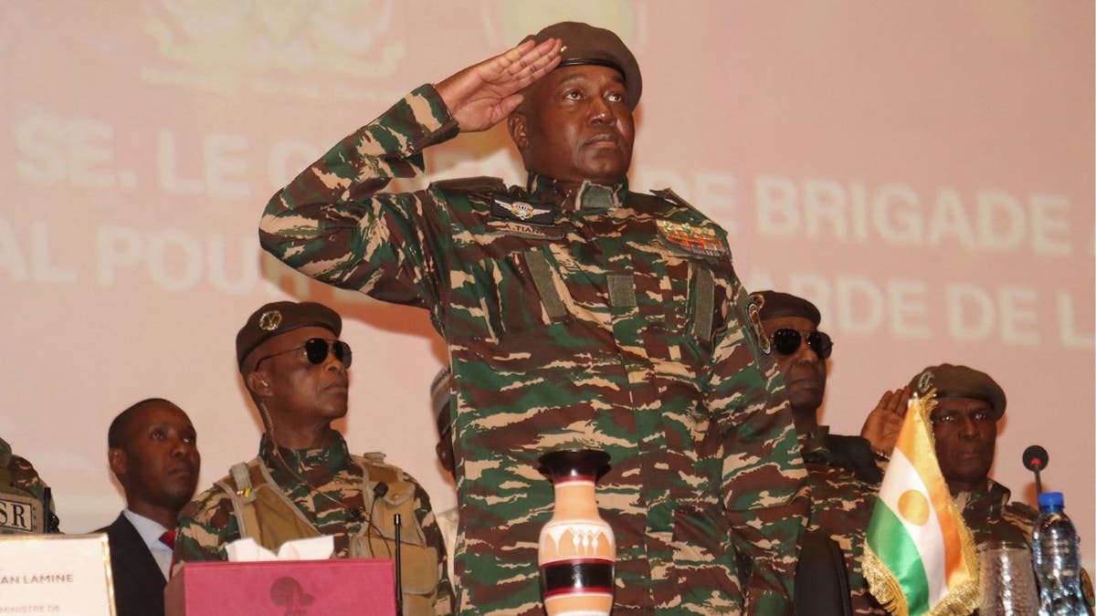 Niger junta leader Gen. Abdourahamane Tchiani salutes during ceremony in Niamey.