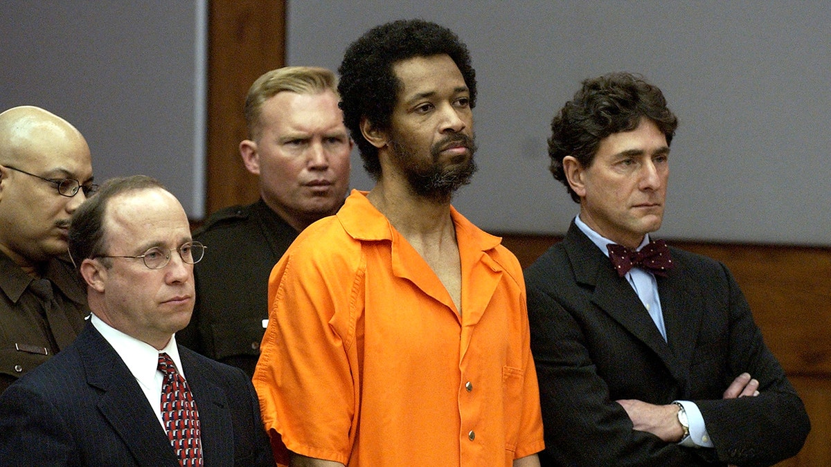 John Allen Muhammad in an orange jumpsuit in court.
