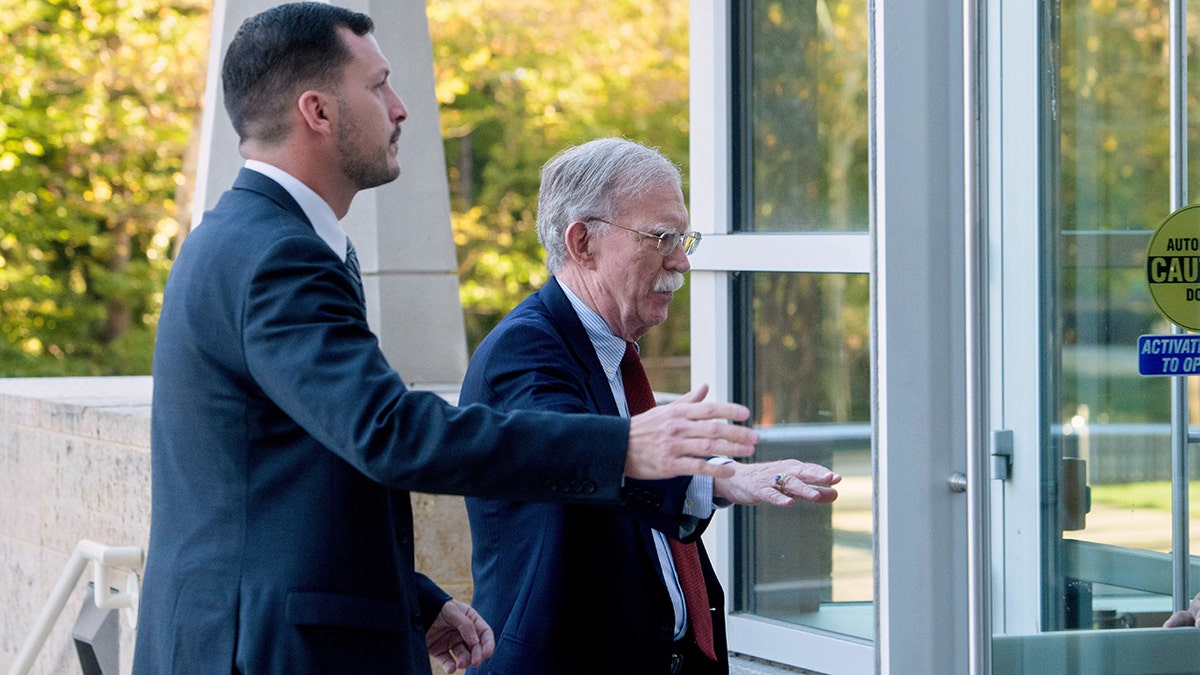 John Bolton sticks out hand as he enters federal courthouse