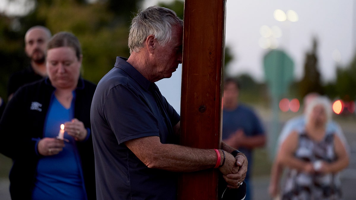 Man prays at vigil for Michigan church shooting victims