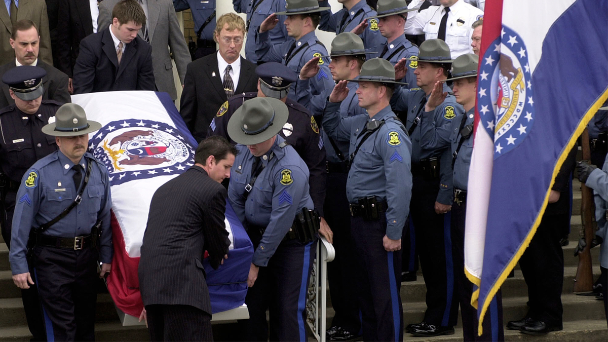 Members of the Missouri State Highway Patrol salute the body of fellow officer Sgt. Carl ''Dewayne'' Graham Jr.