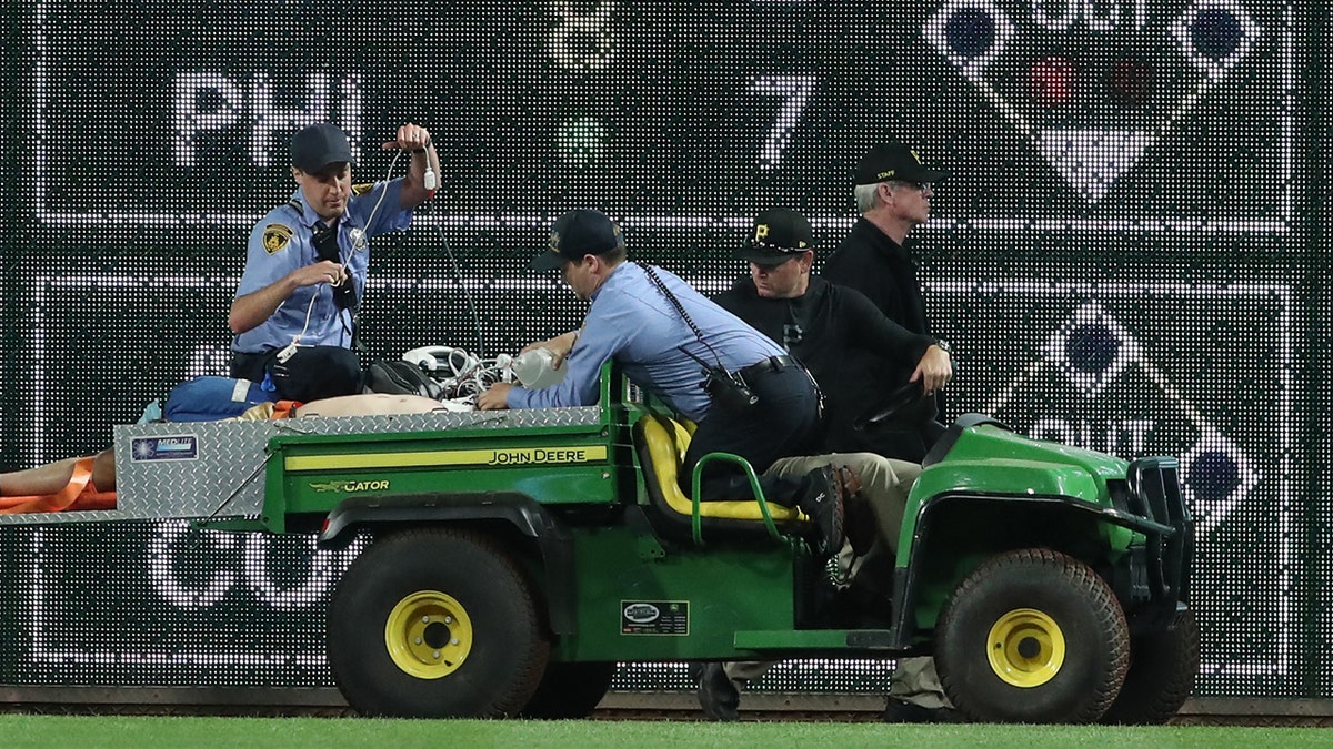 Fan carted off field