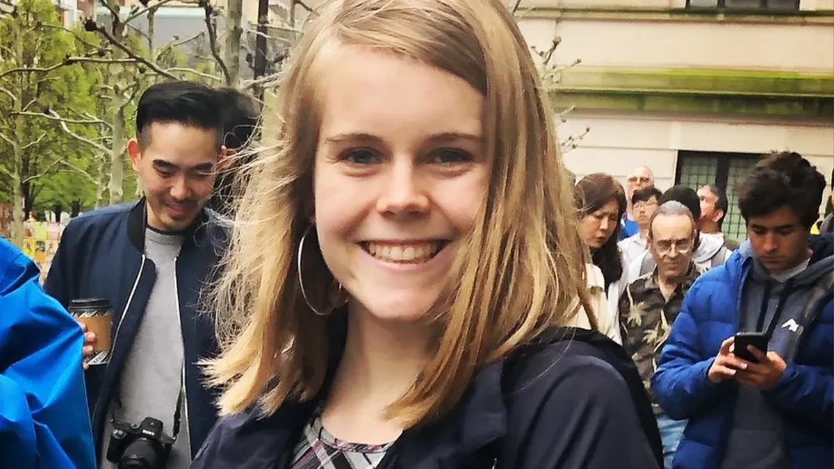 Tessa Majors smiling in this undated photograph, with blonde hair and large hoop earrings, wearing a black shirt