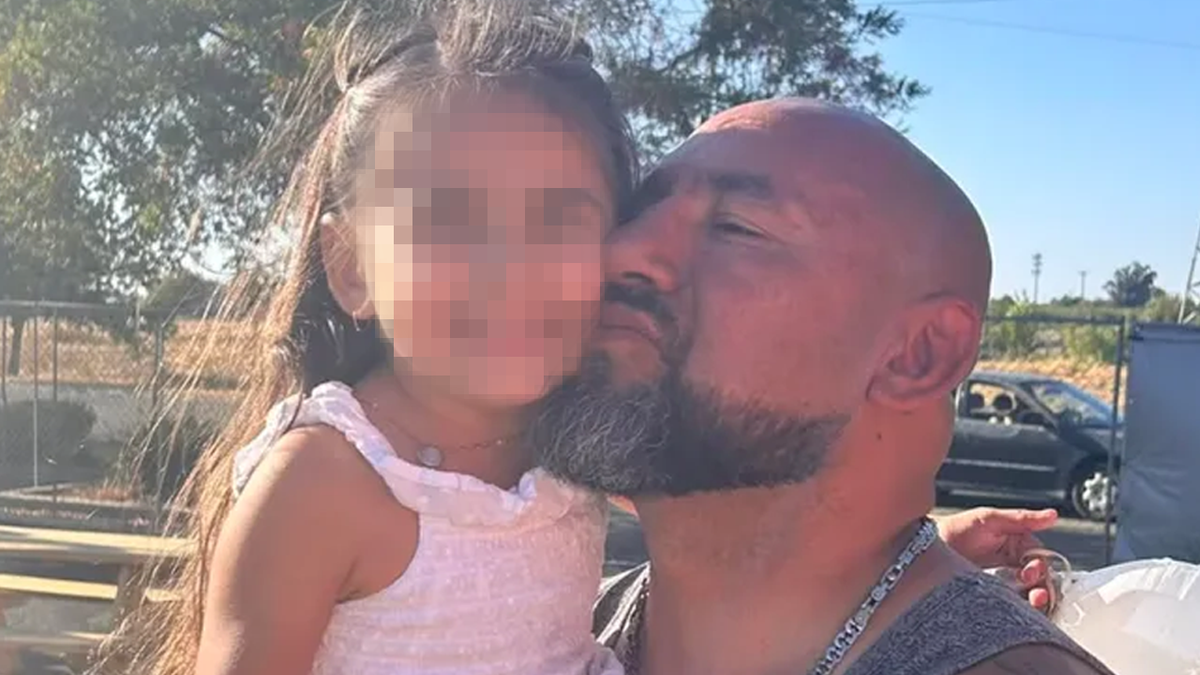 Jason Elola gives kiss to family member