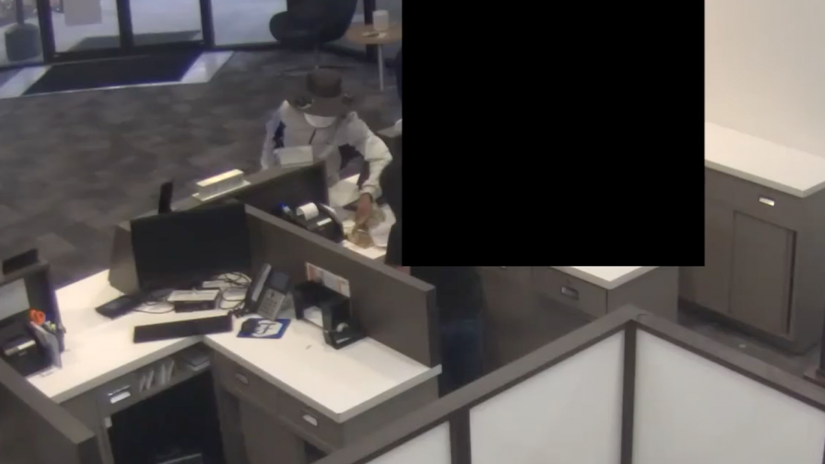 Man robbing bank teller