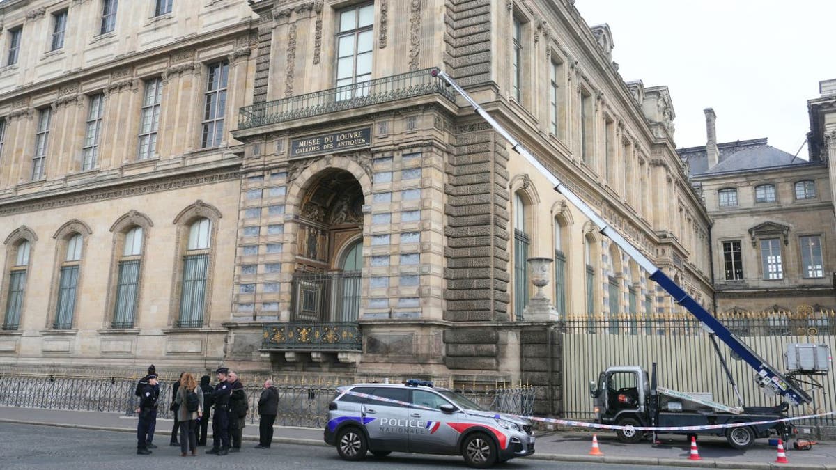Police and moving lift outside the Louvre Museum following jewel heist in Paris.