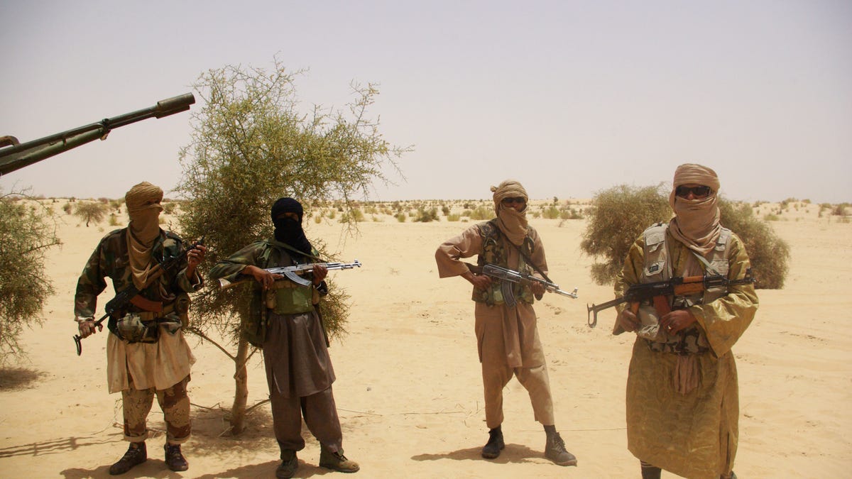 April 24, 2012 - FILE photo: Fighters from Islamist group Ansar Dine stand guard during a hostage handover in the desert outside Timbuktu, Mali.