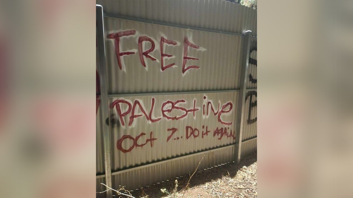 "Free Palestine" graffiti is seen on a fence praising the Oct. 7 Hamas massacre against Israelis.