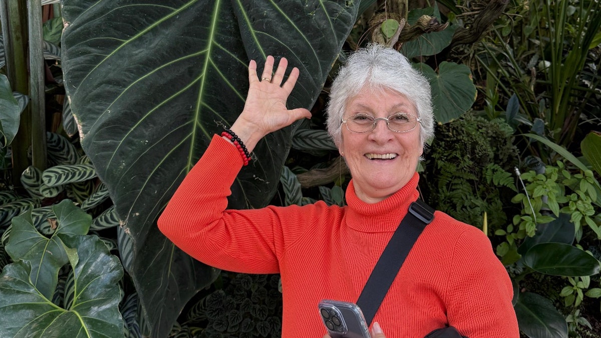 Jeanette Marken in red sweater happy and waving