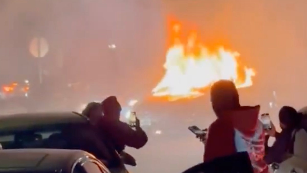 A car is set on fire during a street takeover in New York City