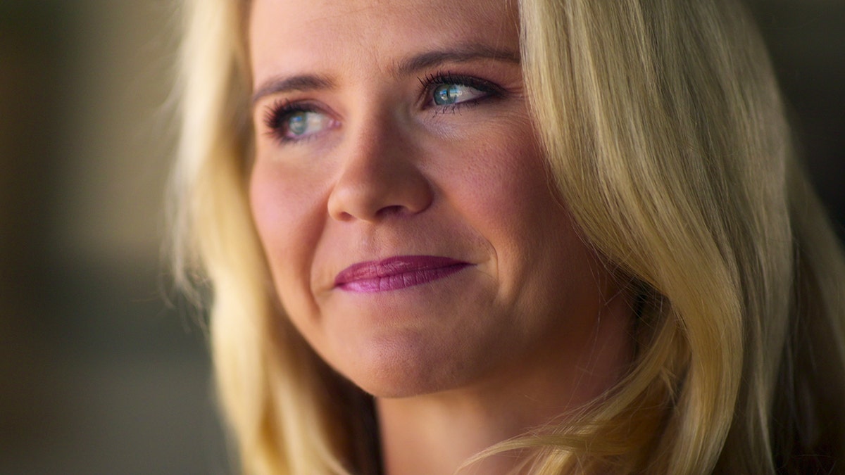 A close-up of Elizabeth Smart looking away.