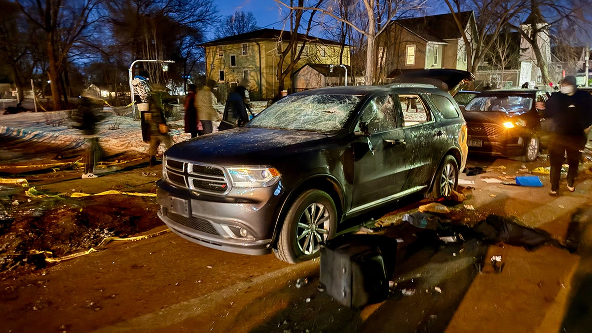 A vehicle is shown vandalized with spray-painted graffiti during unrest in Minneapolis.