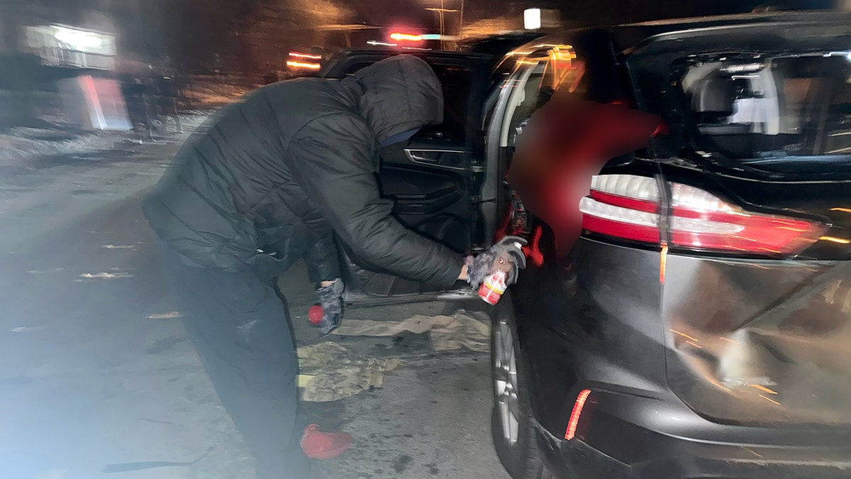A vehicle is shown vandalized with spray-painted graffiti during unrest in Minneapolis.