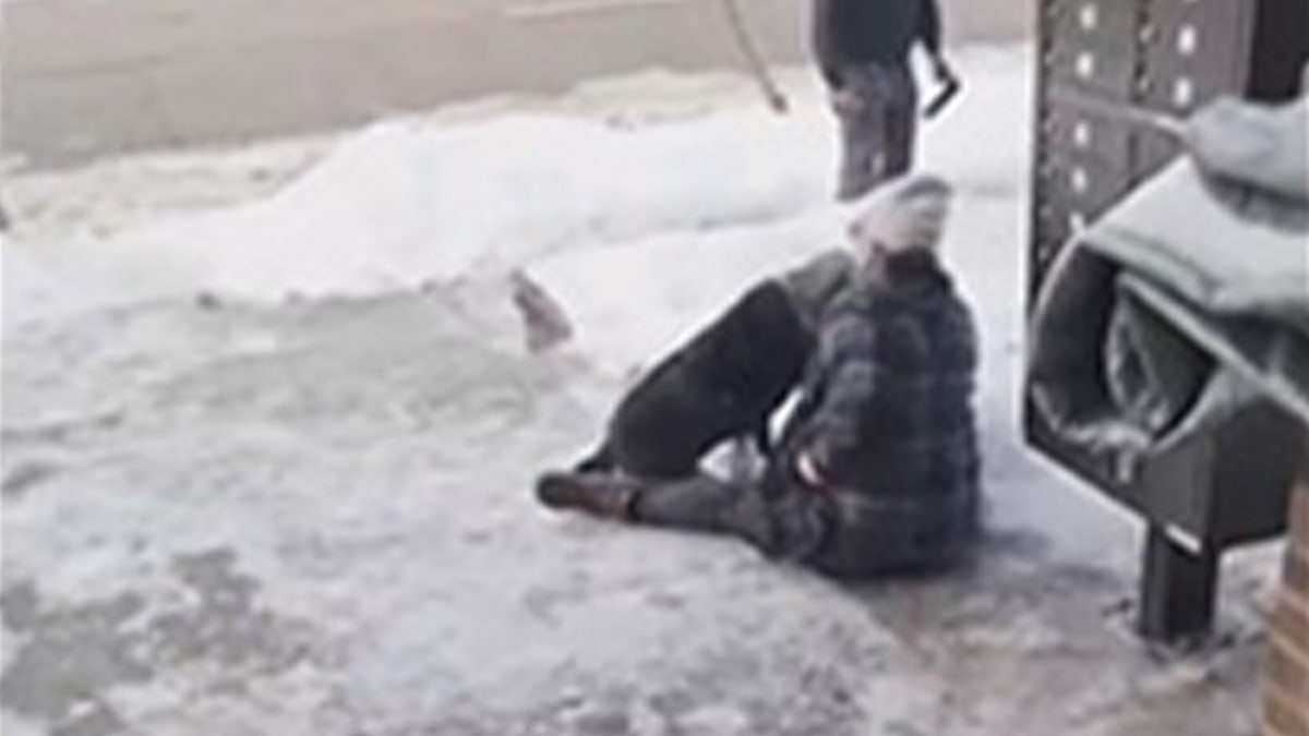 A grieving woman on the sidewalk following the ICE shooting in Minneapolis, Minnesota.